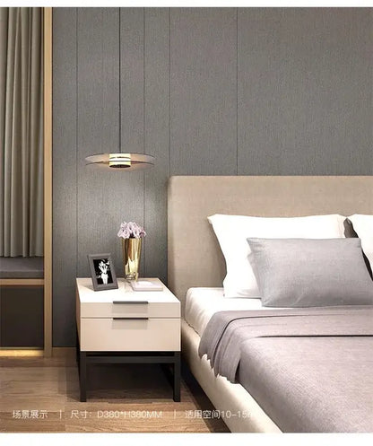 Modern minimalist white nightstand with matte finish and sleek black legs paired with glass pendant lights for dining room