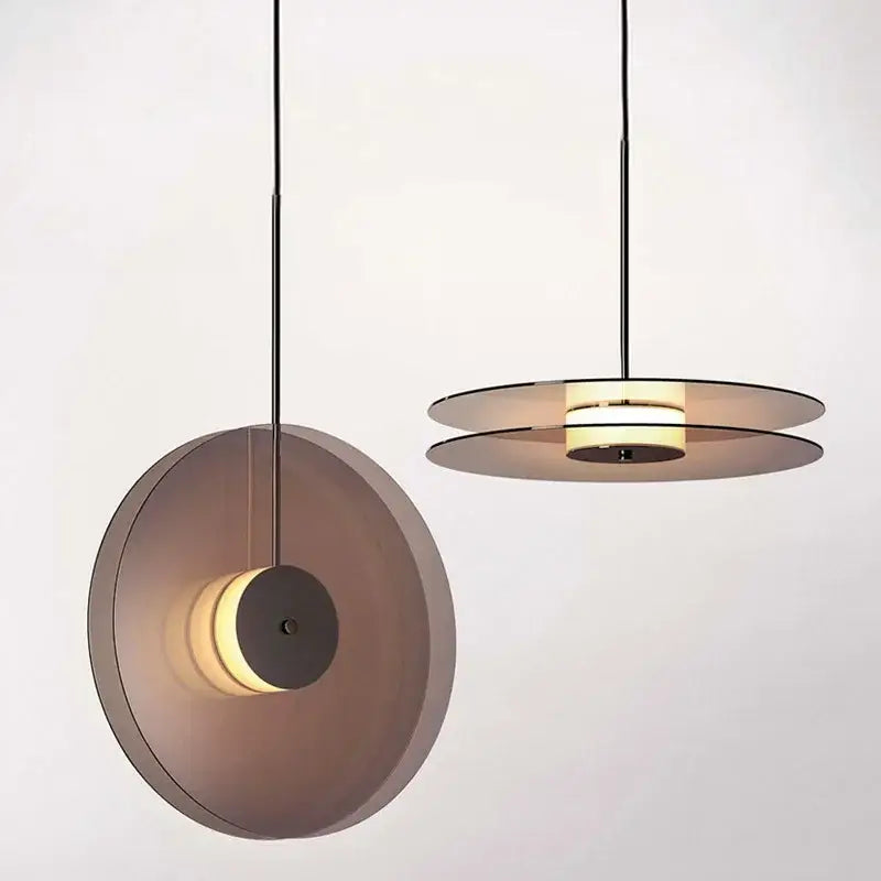Minimalist matte glass pendant lights with translucent smoked shades and black metal frames for dining room illumination