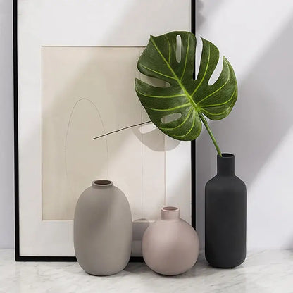 Three minimalist geometric ceramic vases in muted gray blush pink and dark charcoal with matte finish for decorbites decor