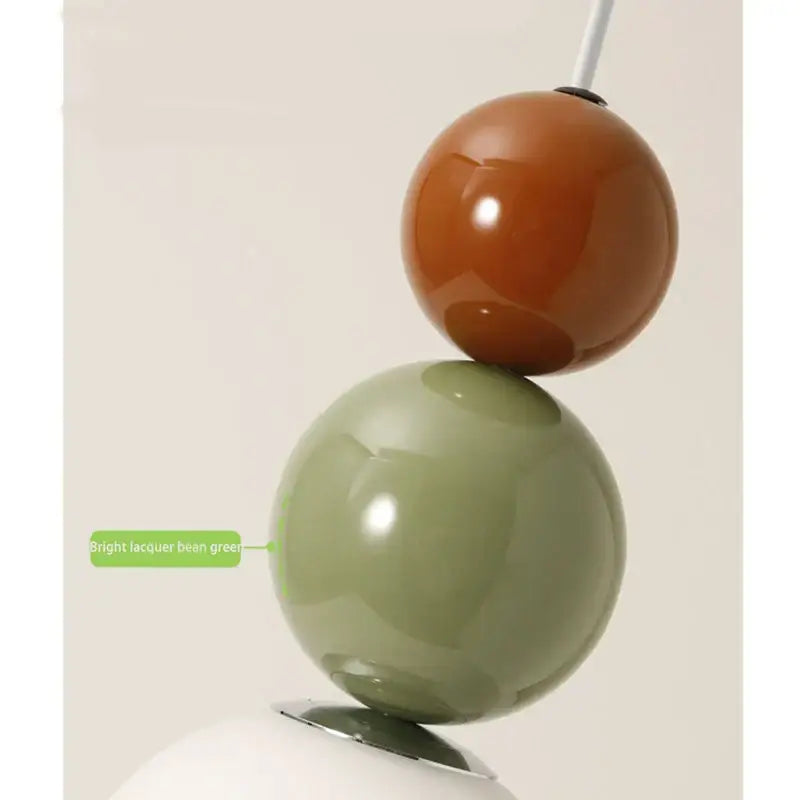 Minimalist nordic pendant light with glossy terracotta and lacquer bean green spherical shades on white base for bedroom decorbites cream style