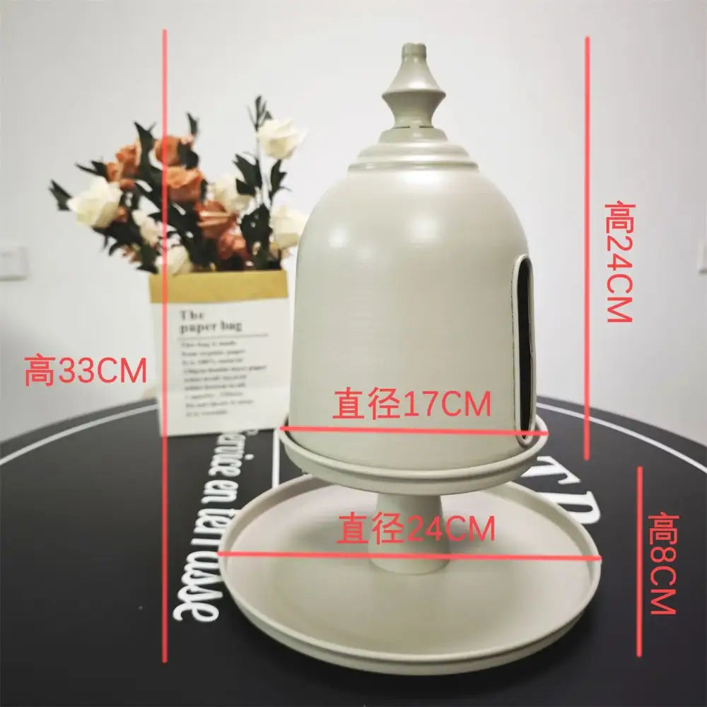 A minimalist off white ceramic birdhouse with domed top and side entrance for decorbites creative paper storage solution