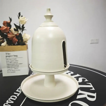 Minimalist cream-colored plastic bell-shaped paper box with narrow slot and pedestal base storage solution by decorbites creative paper