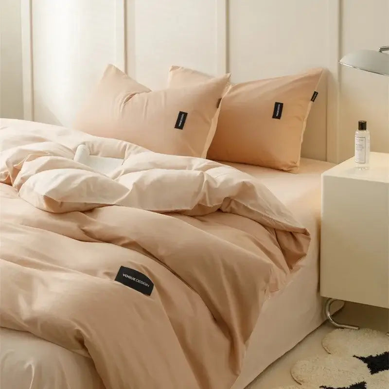 Minimalist beige quilted duvet set with matching cotton bedding and black brand tags in off-white and mint colors