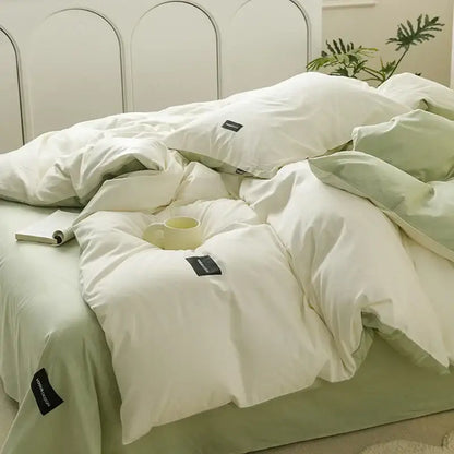 Minimalist off-white and mint matching cotton bedding set with soft white and pale green duvet featuring subtle texture and black tags