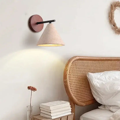Beige cone-shaped wall sconce with matte terracotta base and black arm for minimalist yellow travertine wall lights decorbites iron yellow