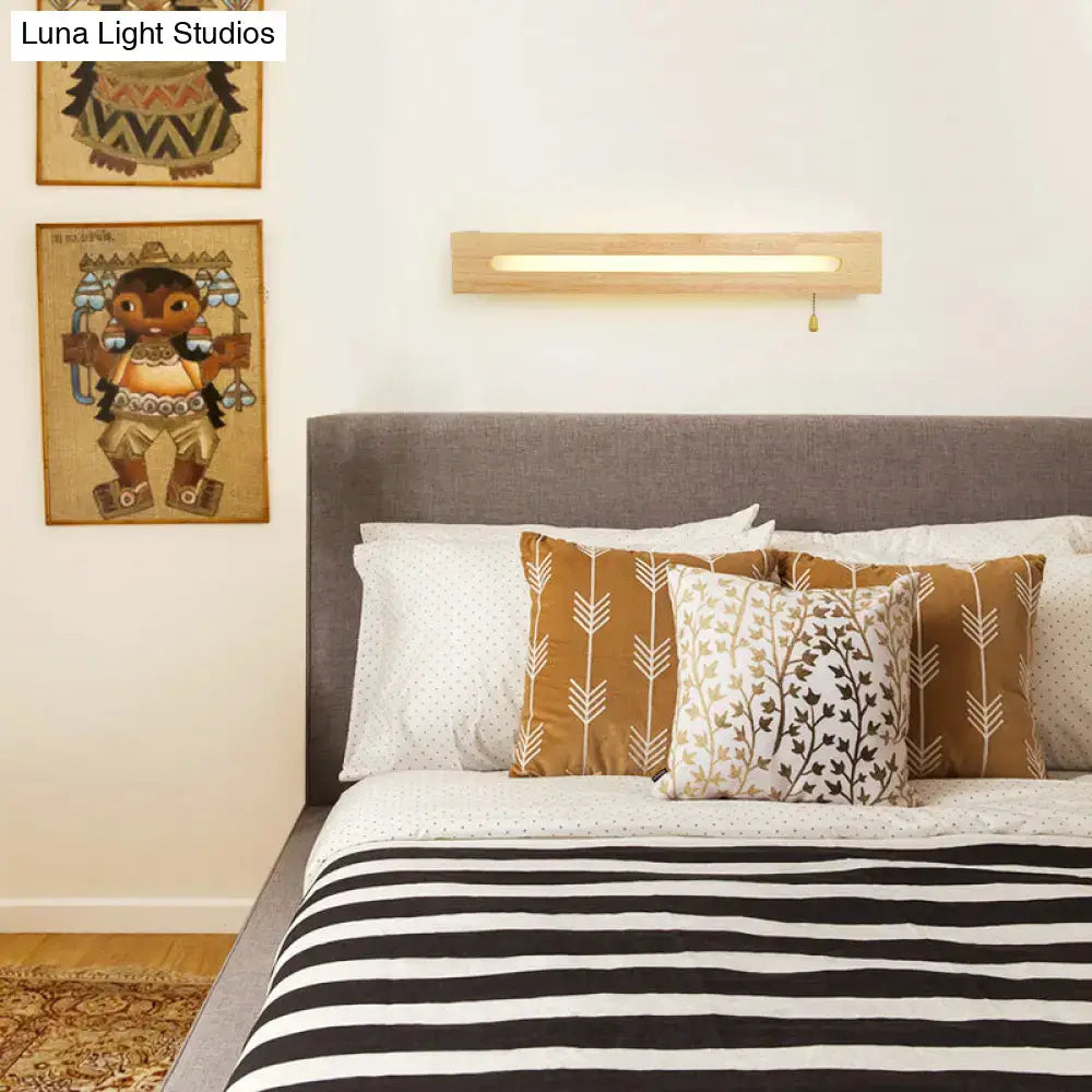 Minimalist rectangular wooden wall sconce with warm glow pull chain and bulb included for bedroom lighting