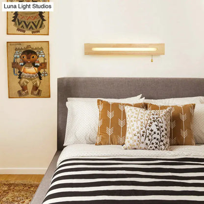 Minimalist rectangular wooden wall sconce with warm glow pull chain and bulb included for bedroom lighting