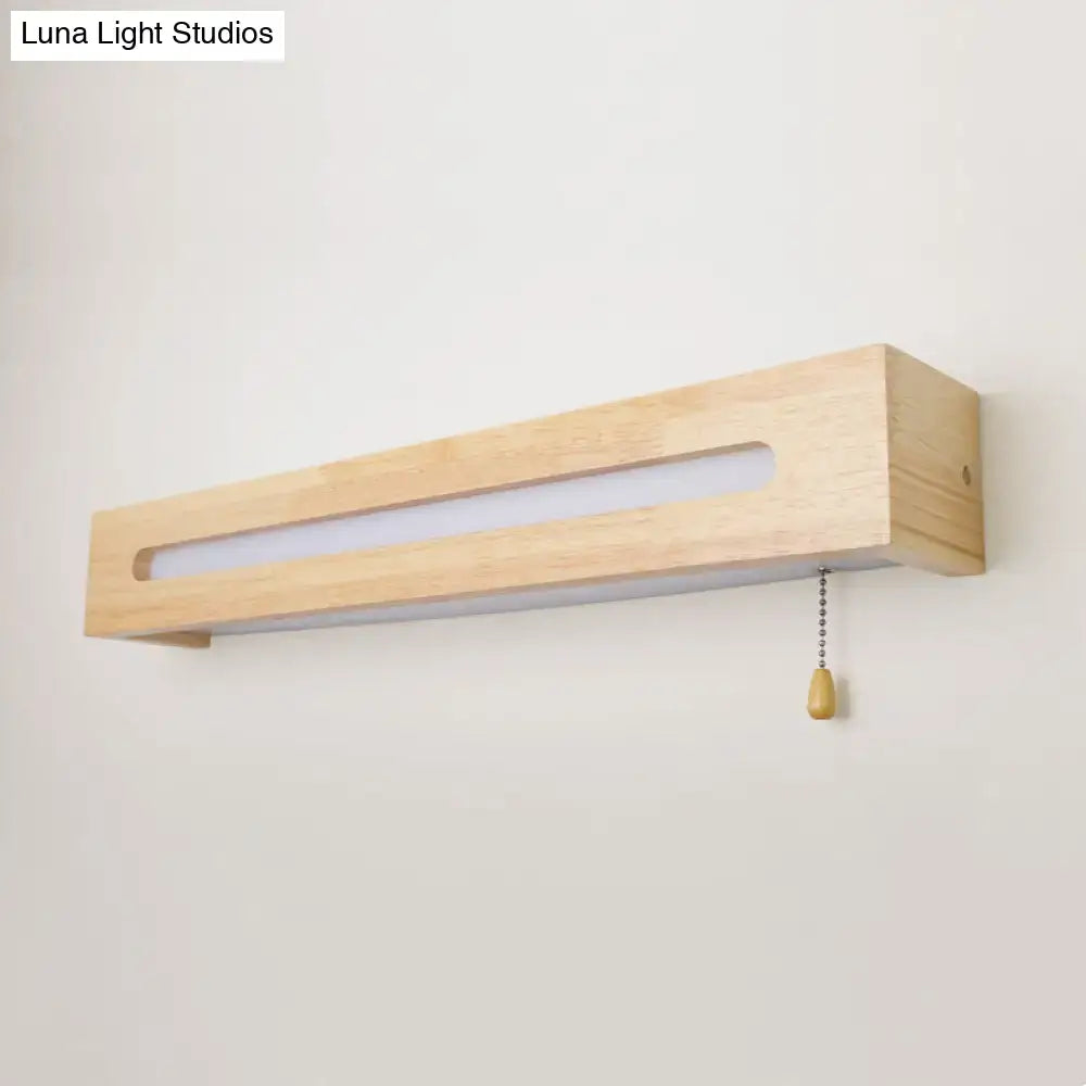 Minimalist rectangular wood wall sconce with natural finish, integrated led strip, pull chain, and bulb included