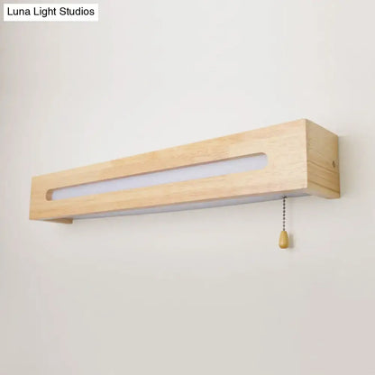 Minimalist rectangular wood wall sconce with natural finish, integrated led strip, pull chain, and bulb included