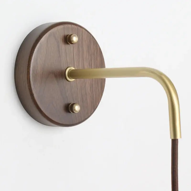 A sleek brass wall lamp with dark wood base and matching hardware for minimalist ribbed ceramic led wall decorbites ceramic led wall