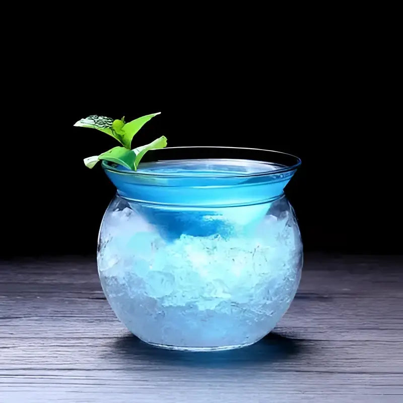 Translucent blue glass 150ml stemless martini chiller filled with ice and garnished with fresh mint for dining room entertaining