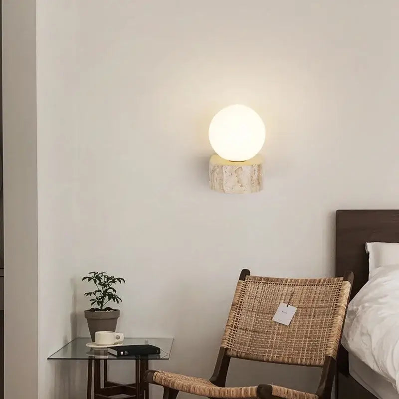 Minimalist warm spherical glass lampshade wall light mounted on textured stone base for bedroom decorbites wall lights