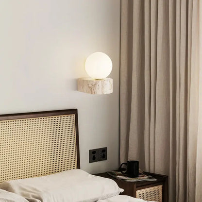 Minimalist stone and glass lampshade wall light with frosted globe on textured base perfect for bedroom wall lights decorbites glass lampshade
