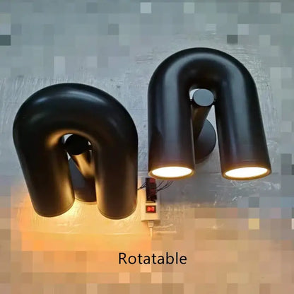 Black minimalist cirkus tube wall sconces with matte finish and warm led lighting for bedroom reading light