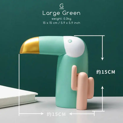 A mint green decorbites bird figurine desk lamp with a gold beak and cactus base for minimalist office decor