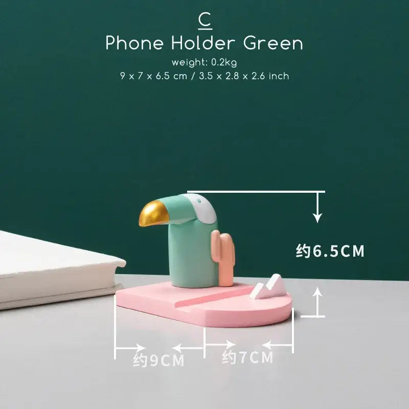 Minimalist turquoise and gold decorbites bird figurine phone holder shaped like a toucan for desktop use