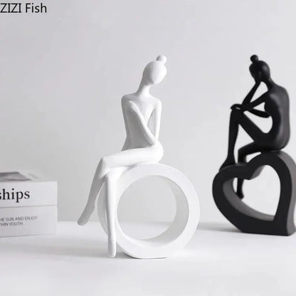 White ceramic minimalist abstract figures sculpture of a seated woman with a bun for living room decor