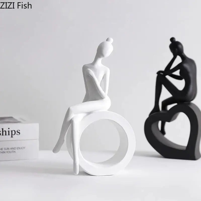 White ceramic minimalist abstract figures sculpture of a seated woman with a bun for living room decor