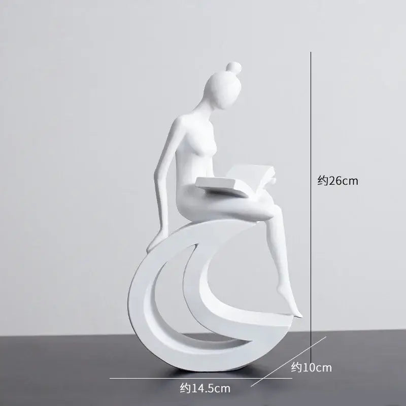 Minimalist white resin abstract figures sculpture of a woman seated on a crescent base reading a book for living room decor