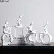 Minimalist white resin abstract figures sculpture featuring stylized women on geometric bases for living room decor