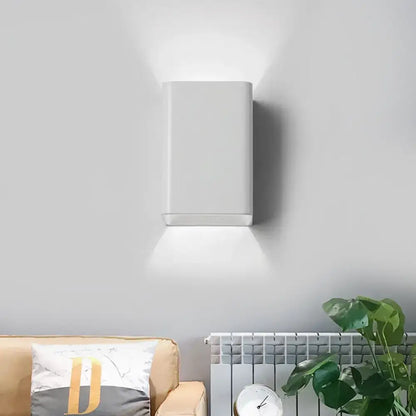 Minimalist white and brass wall lamp with cube shade featuring sleek modern design for bedroom lighting