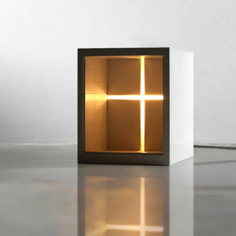 Minimalist white concrete church table lamp with black frame and warm glowing cross light for bedroom night decorbites concrete church