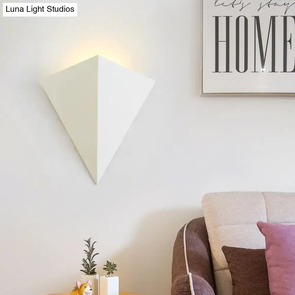 A sleek white triangular minimalist led wall lamp ideal for living room decor and modern lighting