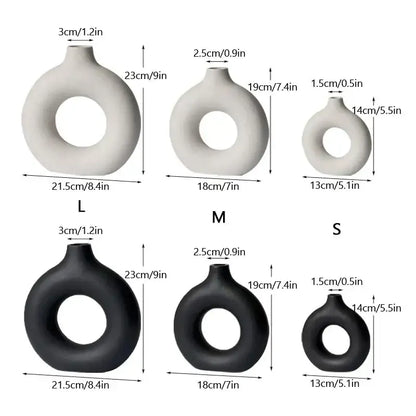 Set of three minimalist decorbites ceramic donut vases in white and black with smooth matte finishes for living room