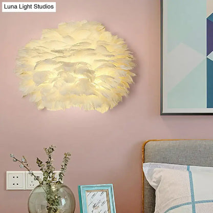 Minimalist white feather floral wall sconce with a soft cream-colored fluffy cloud-like design for bedroom lighting