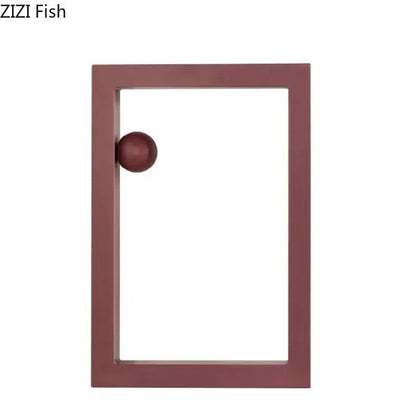 Maroon rectangular frame with matching spherical knob as minimalist decorbites geometric circle desk ornament in office decor