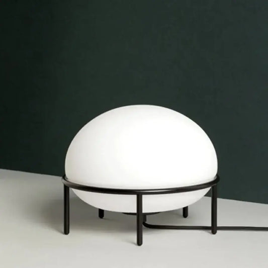 Minimalist white glass ball table lamp with smooth spherical globe on black metal frame ideal for bedroom decorbites glass ball