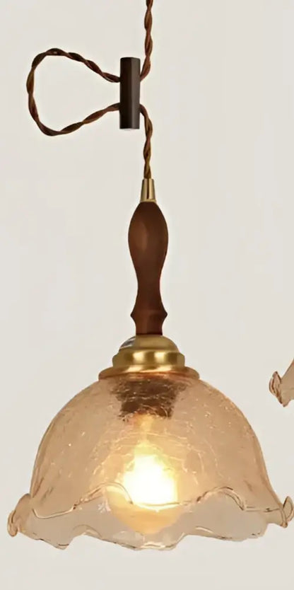 Minimalist white glass pendant light with warm-toned textured glass, wooden handle, and brass accents for dining room pendant lights