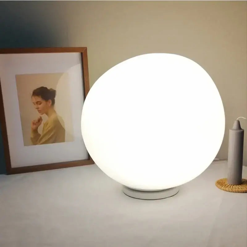 A sleek glowing white spherical floor lamp with matte finish minimalist design for decorbites goose egg led decor