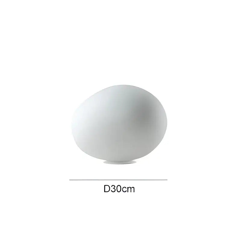 A sleek matte white ceramic floor lamp with a dome shape and subtle base perfect for decorbites goose egg led decor