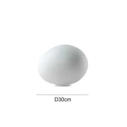 A sleek matte white ceramic floor lamp with a dome shape and subtle base perfect for decorbites goose egg led decor