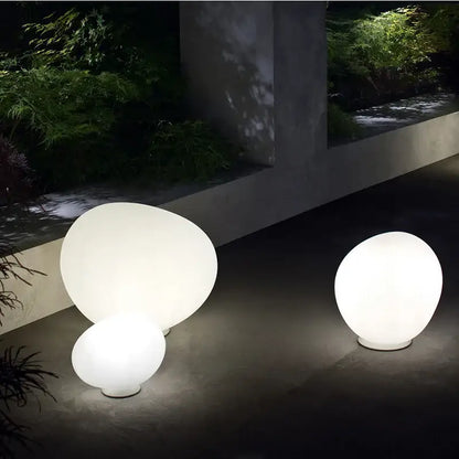 Two illuminated smooth white spherical floor lamps with minimalist design for decorbites goose egg led bedroom decor