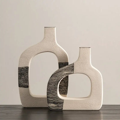 Two modern ceramic flower vases with matte white finish and black geometric stripes for living room decor