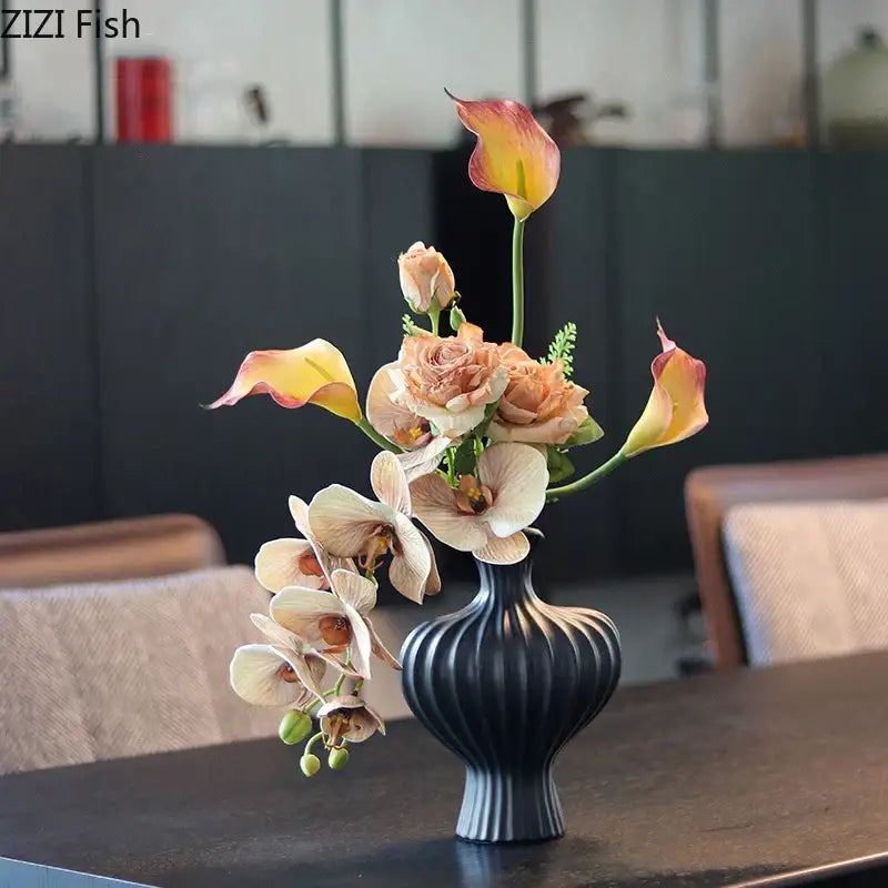 Black ribbed ceramic vase with peach and cream flowers complementing minimalist heart shape ceramic decorbites heart shape decor