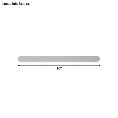 A sleek 16-inch silver metallic wall sconce providing warm white light for minimalist bathroom decor