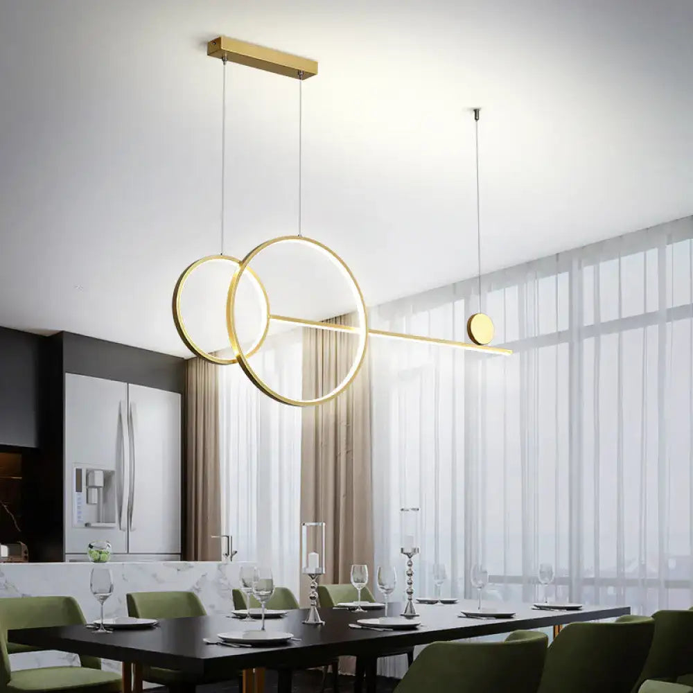 Modern gold-toned circular linear led hanging lamp with intersecting rings and sleek horizontal bar for dining rooms