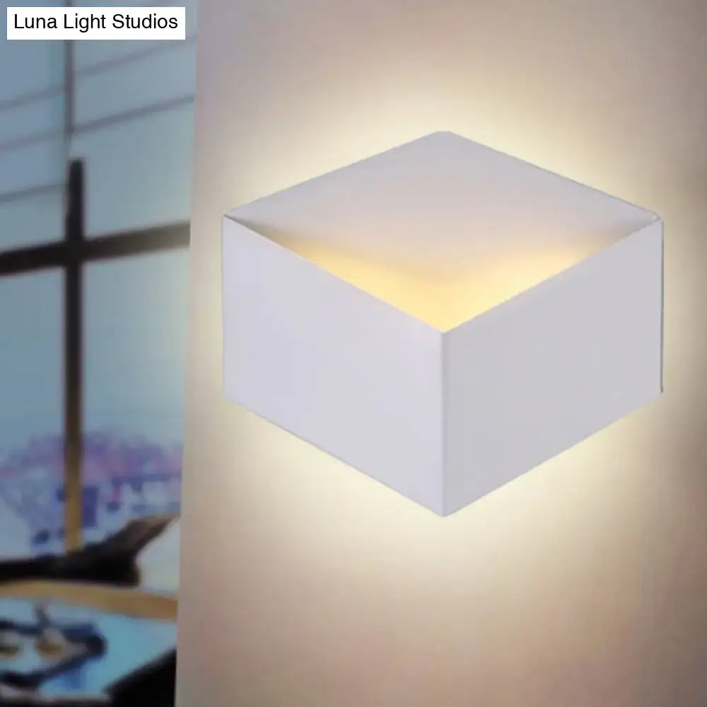 Minimalist white metallic geometric wall lamp with a cube shape and warm glow for corridor wall mount lighting