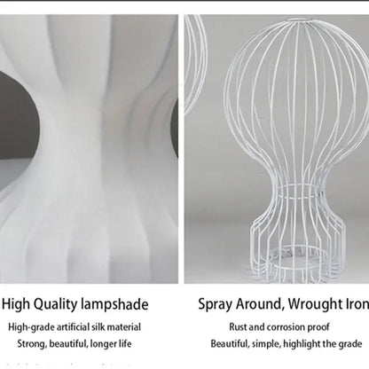 Minimalist white ribbed cocoon silk table lamp with spherical wireframe shade and curved base for bedroom decorbites gatto cocoon