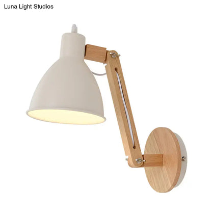 Minimalist white swing arm wall light with matte metal lampshade and light wood articulated arm for bedroom use