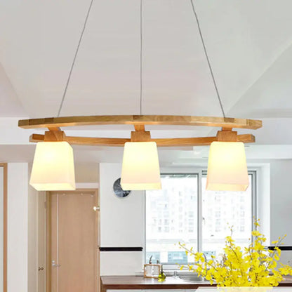 Modern wooden pendant light with three warm-toned fabric shades and minimalist suspension pendant for dining room lighting