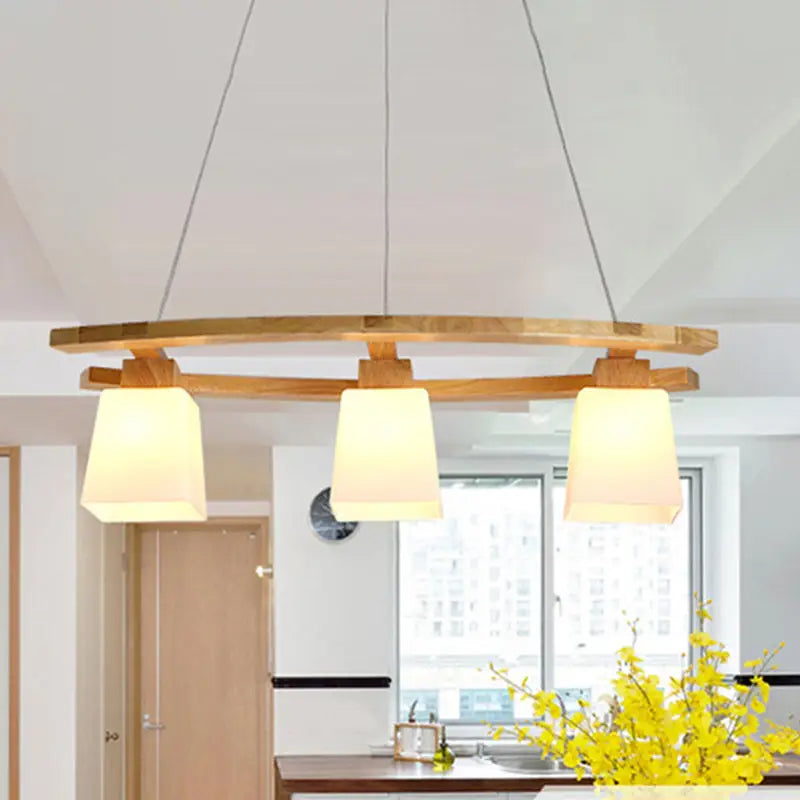 Modern wooden pendant light with three warm-toned fabric shades and minimalist suspension pendant for dining room lighting