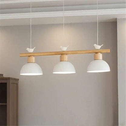 Minimalist wood and white decorbites bird light pendant with natural wood bar and white ceramic birds for dining room