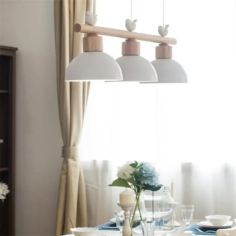 White ceramic decorbites bird light pendant with wooden accents for minimalist dining room lighting