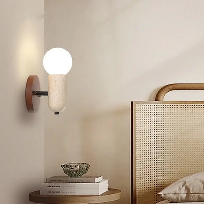 A modern led wall sconce with a matte white speckled glass globe and warm wood backplate for bedroom decorbites light