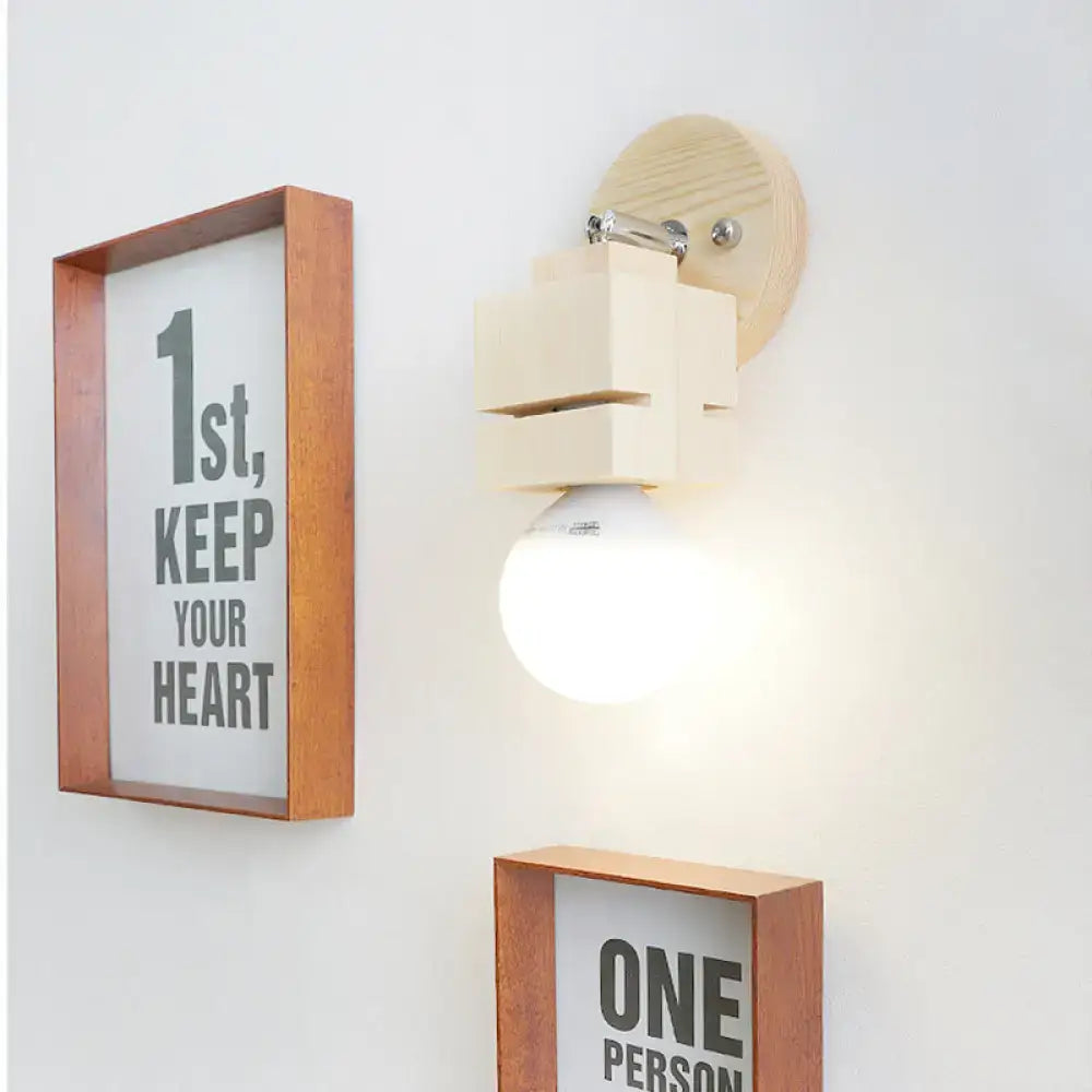 Minimalist wood wall lamp with light wood circular backplate and off-white wooden blocks supporting led bulb 110v-240v