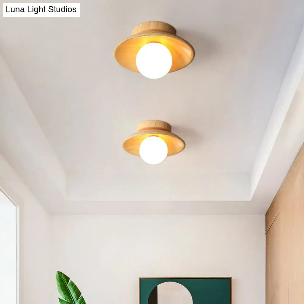 Two decorbites™ sleek wooden ceiling lights with warm wooden shades and white bulbs in mini semi flush mount design
